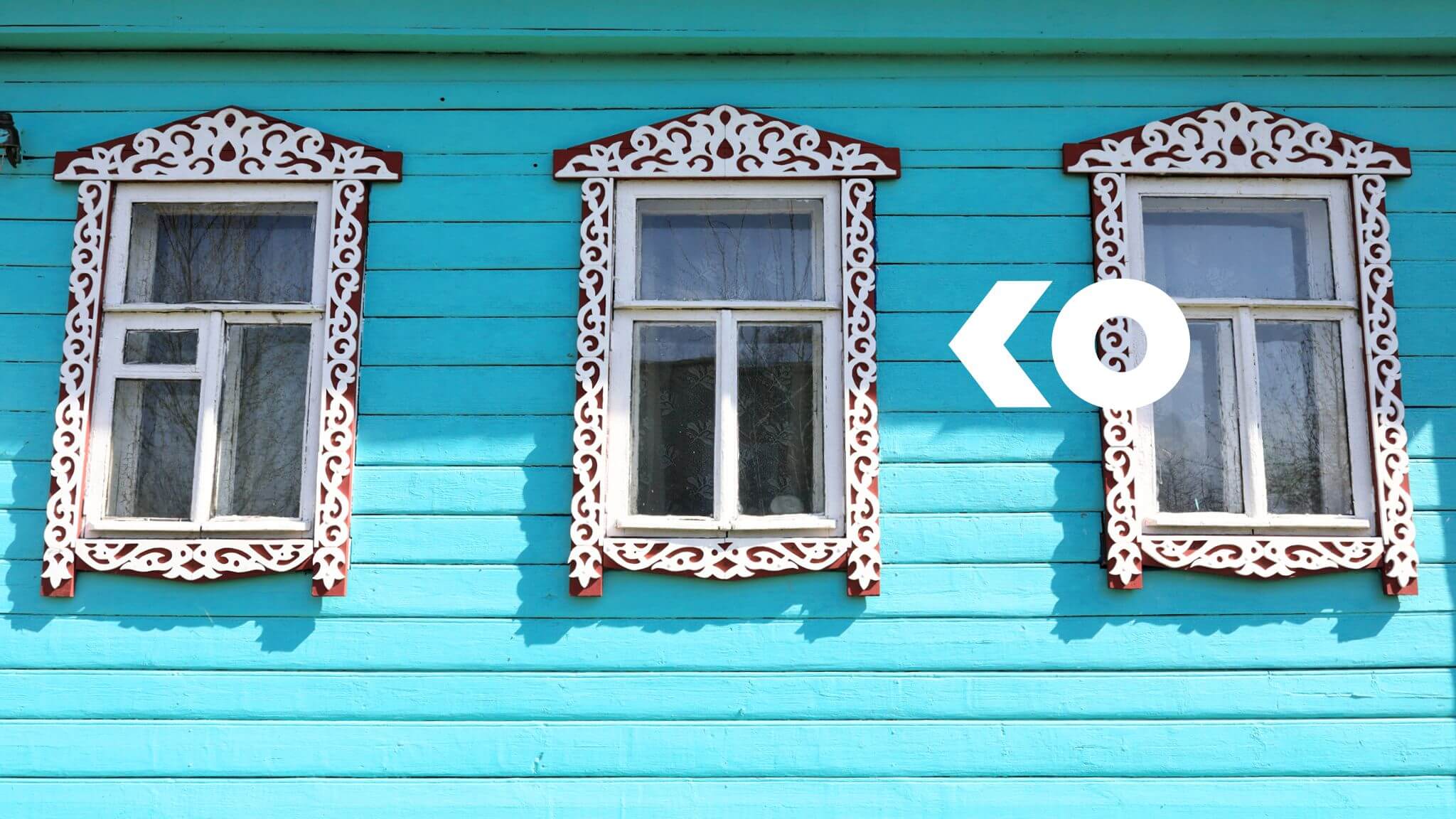 Blue House with three decorative windows and arrow pointing to indicate coverate at that place