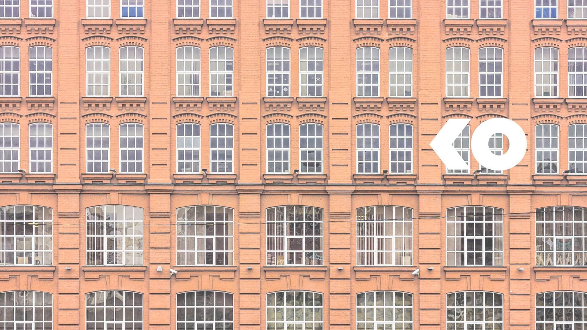 Pink multi-floored building with many windows