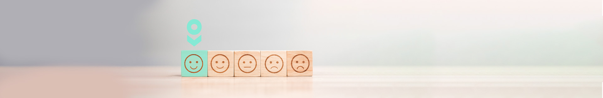 Happy and sad faces on blocks with the happy face coloured in for Konnect